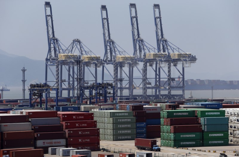 &copy; Reuters. A truck drives past shipping containers at a port in Ningbo, Zhejiang province July 9, 2013.  REUTERS/William Hong 