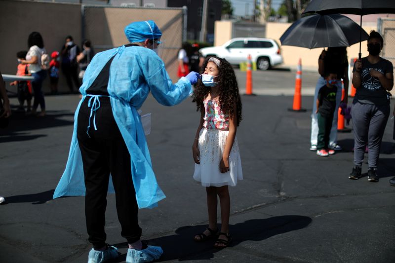&copy; Reuters. Alisson Argueta, 8, is given a coronavirus disease (COVID-19) test at a back-to-school clinic in South Gate, Los Angeles, California, U.S., August 12, 2021. REUTERS/Lucy Nicholson