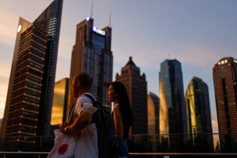 &copy; Reuters. FILE PHOTO: People walk in Lujiazui financial district during sunset in Pudong, Shanghai, China July 13, 2021. Picture taken July 13, 2021. REUTERS/Aly Song  