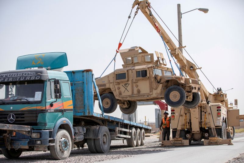 &copy; Reuters. FILE PHOTO: U.S. Army soldiers and contractors load High Mobility Multi-purposed Wheeled Vehicles, HUMVs, to be sent for transport as U.S. forces prepare for withdrawal, in Kandahar, Afghanistan, July 13, 2020. U.S. Army/Sgt. Jeffery J. Harris/Handout via