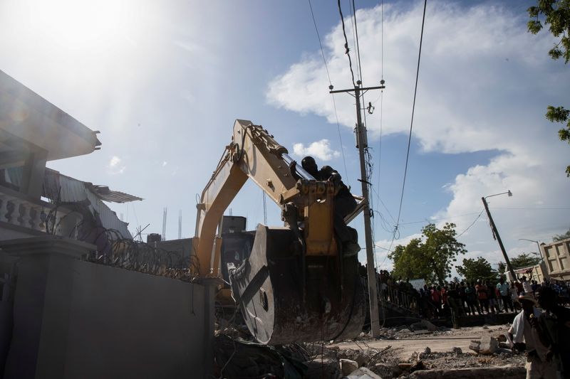 Storm brings floods as Haitians seek help at overloaded hospitals after quake