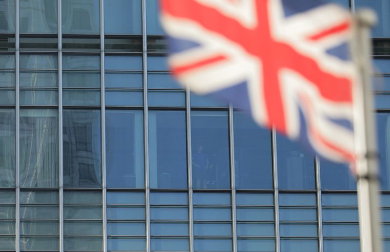 &copy; Reuters. FILE PHOTO: A man looks from a building in the financial district of Canary Wharf in London, Britain November 3, 2017. REUTERS/Kevin Coombs