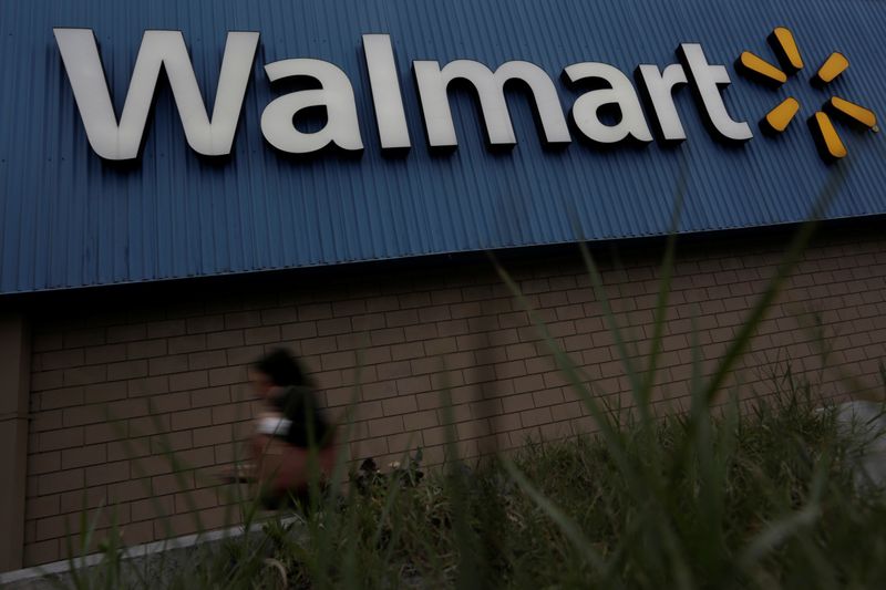&copy; Reuters. A woman walks by a logo of Walmart outside a store in Monterrey, Mexico February 12, 2018. Picture taken February 12, 2018. REUTERS/Daniel Becerril