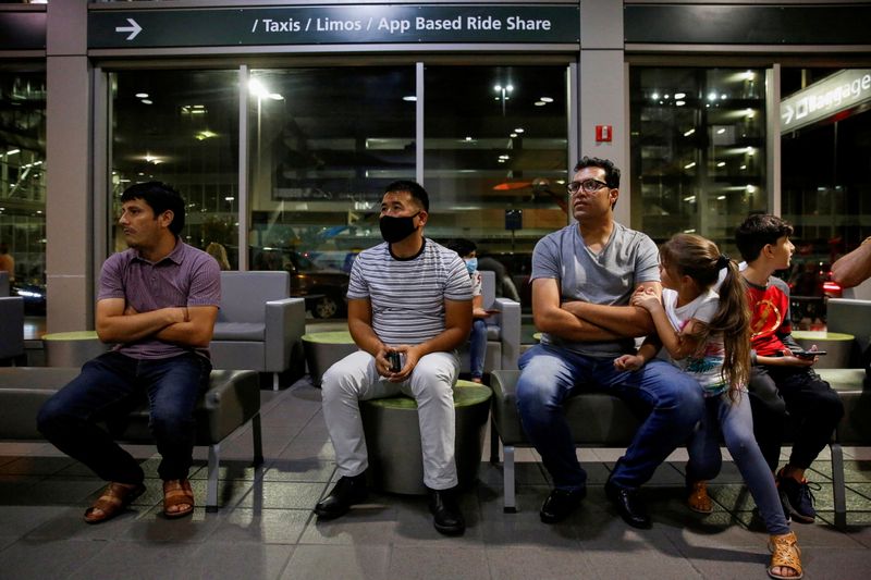 &copy; Reuters. FILE PHOTO: Sayed Abdul Wase Majidi's older brother Sayad Khalil Majidi waits for his arrival along with Majidi's niece, Stayesh Majidi, 6, nephew Said Mustafa Miri, 38, and Afghan Community organizer Besmellah Khuram at the Sacramento International Airpo