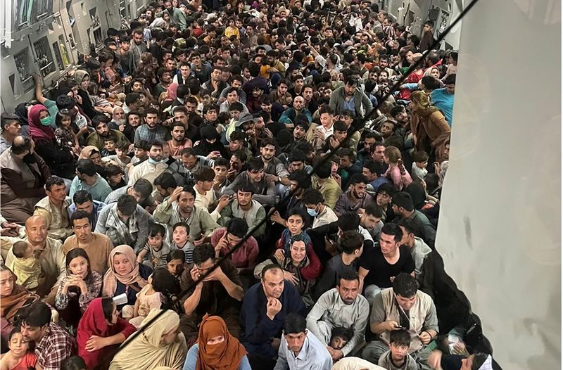 &copy; Reuters. Evacuees crowd the interior of a U.S. Air Force C-17 Globemaster III transport aircraft, carrying some 640 Afghans to Qatar from Kabul, Afghanistan, August 15, 2021.    Courtesy of Defense One/via REUTERS