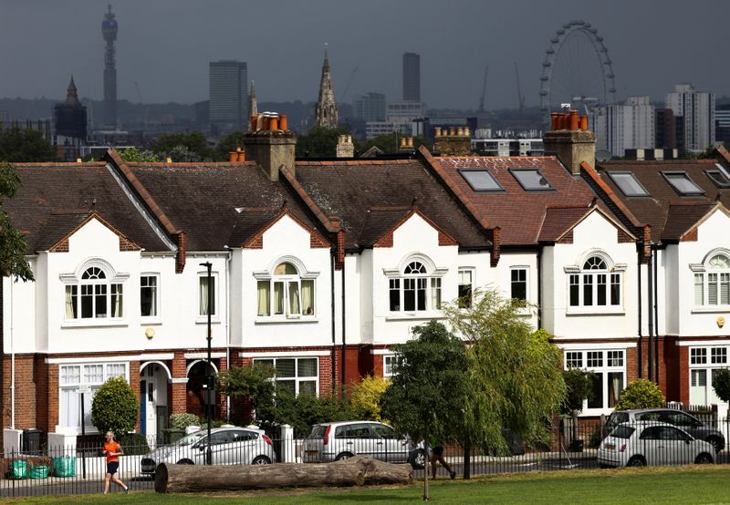 &copy; Reuters. A person jogs past a row of residential housing in south London, Britain, August 6, 2021. REUTERS/Henry Nicholls