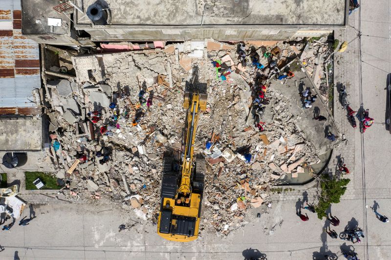 © Reuters. An aerial view of an excavator removing rubble from a destroyed building after Saturday's 7.2 magnitude quake, in Les Cayes, Haiti August 18, 2021. REUTERS/Ricardo Arduengo