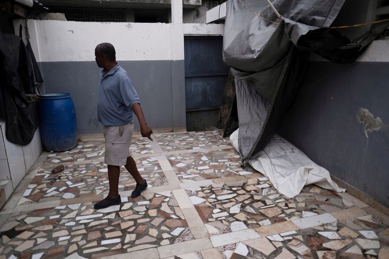 &copy; Reuters. A man walks at a morgue after Saturday's 7.2 magnitude quake, in Les Cayes, Haiti August 17, 2021. REUTERS/Ricardo Arduengo