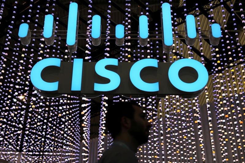 &copy; Reuters. FILE PHOTO: A man passes under a Cisco sign at the Mobile World Congress in Barcelona, Spain, February 25, 2019. REUTERS/Sergio Perez/File Photo