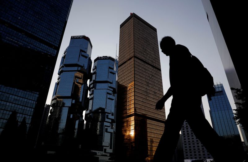 &copy; Reuters. FILE PHOTO: A man walks past buildings at a business district in Hong Kong, China, November 4, 2019. REUTERS/Kim Kyung-Hoon