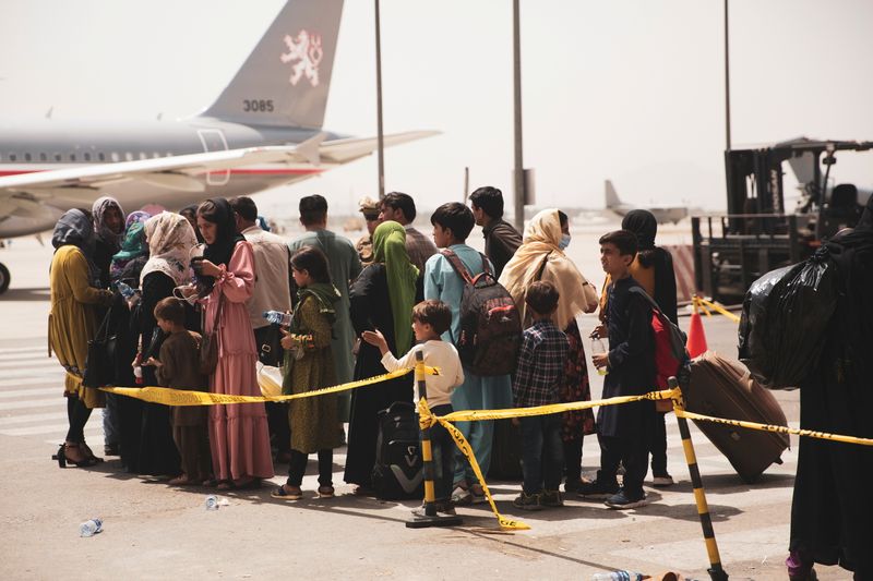 &copy; Reuters. FILE PHOTO: Civilians prepare to board a plane during an evacuation at Hamid Karzai International Airport, Kabul, Afghanistan August 18, 2021. Picture taken August 18, 2021.  U.S. Marine Corps/Staff Sgt. Victor Mancilla/Handout via REUTERS 