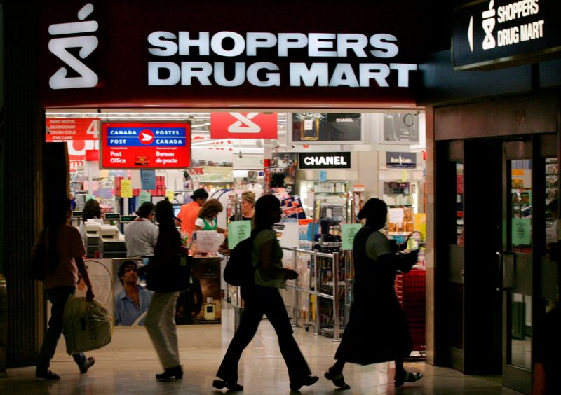 &copy; Reuters. FILE PHOTO: People walk past a Shoppers Drug Mart store in Toronto July 19, 2006. REUTERS/Peter Jones