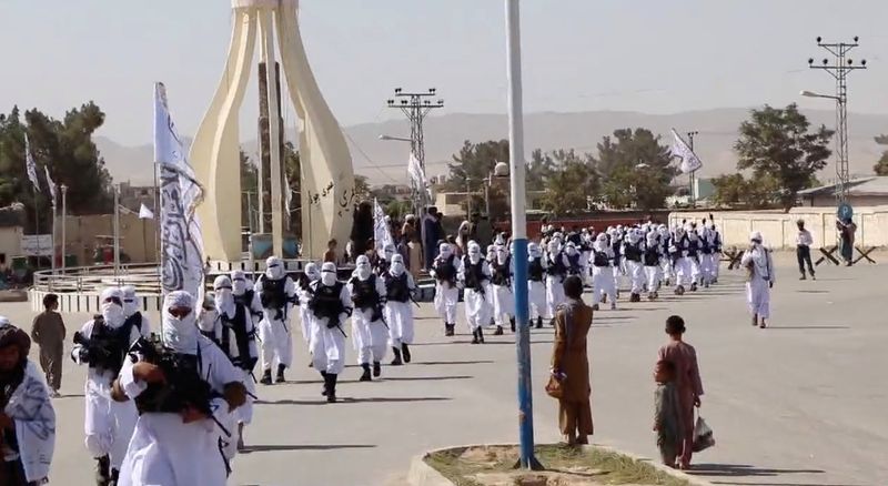 &copy; Reuters. FILE PHOTO: Taliban fighters march in uniforms on the street in Qalat, Zabul Province, Afghanistan, in this still image taken from social media video uploaded August 19, 2021 and obtained by REUTERS 