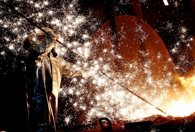 &copy; Reuters. FILE PHOTO: A steel worker of Germany's industrial conglomerate ThyssenKrupp AG stands a mid of emitting sparks of raw iron from a blast furnace at Germany's largest steel factory in Duisburg, Germany. REUTERS/Wolfgang Rattay