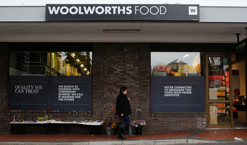 &copy; Reuters. FILE PHOTO: A woman walks past an outlet of retailer Woolworths in Cape Town, South Africa, June 19, 2017. REUTERS/Mike Hutchings