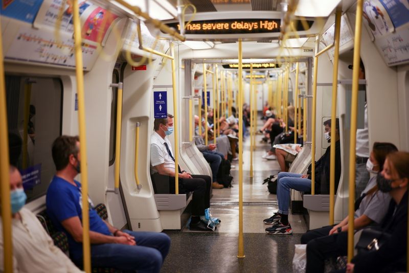 © Reuters. FILE PHOTO: People ride aboard a London Underground train, in central London, Britain, June 11, 2021. REUTERS/Henry Nicholls/File Photo