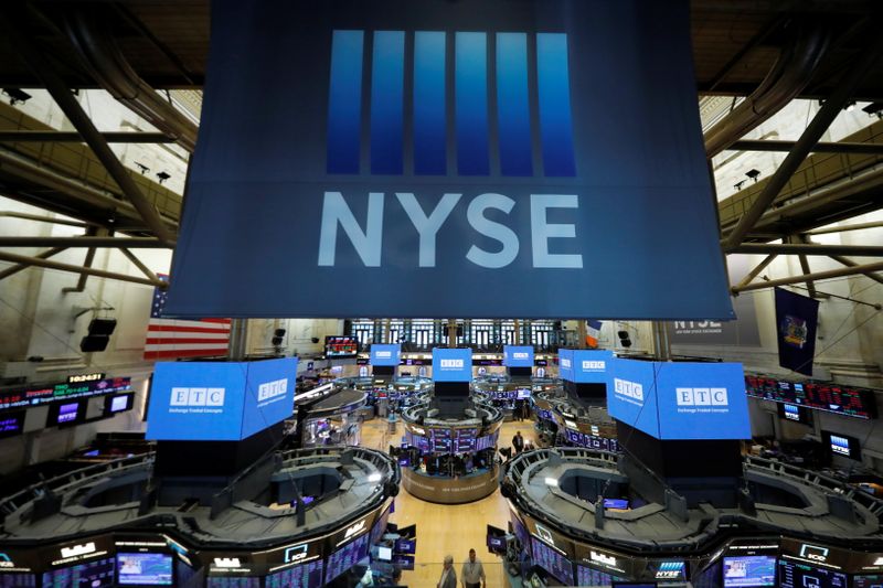 © Reuters. Signage hangs over the trading floor at the New York Stock Exchange (NYSE) in Manhattan, New York City, U.S., August 19, 2021. REUTERS/Andrew Kelly