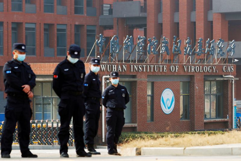 &copy; Reuters. FILE PHOTO: Security personnel keep watch outside Wuhan Institute of Virology during the visit by the World Health Organization (WHO) team tasked with investigating the origins of the coronavirus disease (COVID-19), in Wuhan, Hubei province, China Februa