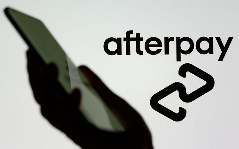 &copy; Reuters. FILE PHOTO: A smartphone is held in front of a displayed Afterpay logo in this illustration taken, August 2, 2021. REUTERS/Dado Ruvic/Illustration/File Photo