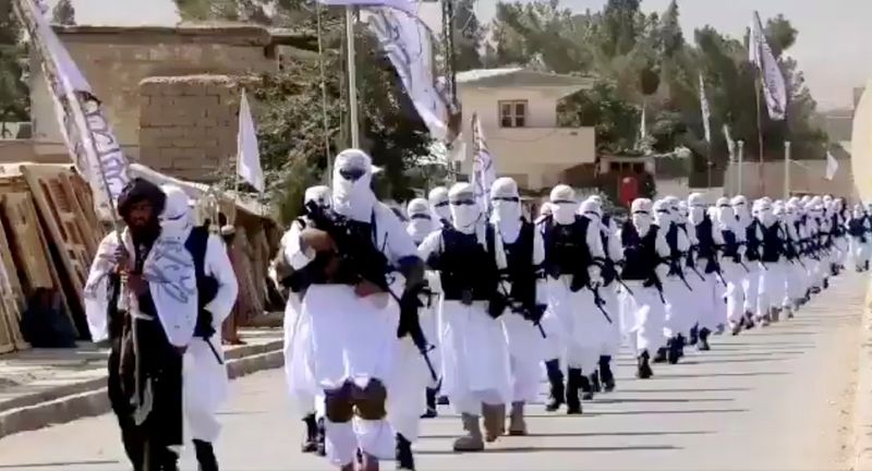 &copy; Reuters. FILE PHOTO: Taliban fighters march in uniforms on the street in Qalat, Zabul Province, Afghanistan, in this still image taken from social media video uploaded August 19, 2021 and obtained by REUTERS