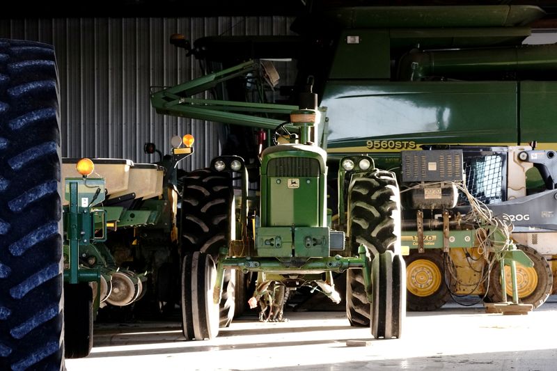 &copy; Reuters. FILE PHOTO: A John Deere tractor, a combine, and other heavy machinery sit inside a barn on a corn and soybean farm in Woodburn, Indiana, U.S., October 16, 2020.  REUTERS/Bing Guan/File Photo