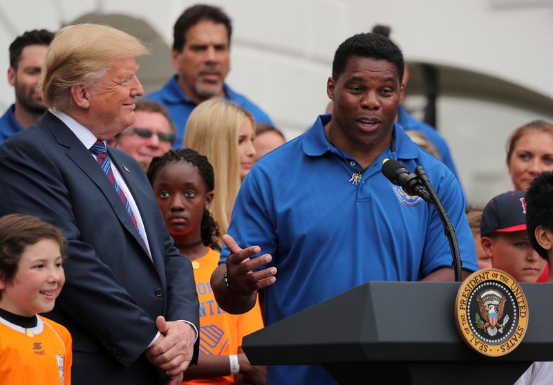 &copy; Reuters. FILE PHOTO: U.S. President Donald Trump listens to former NFL star Herschel Walker speak during the White House Sports and Fitness Day event on the South Lawn of the White House in Washington, U.S., May 30, 2018.  REUTERS/Jonathan Ernst