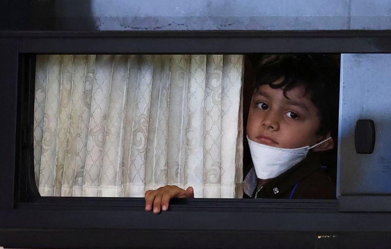&copy; Reuters. FILE PHOTO: An Afghan boy looks on as he leaves Incheon International Airport after arriving in South Korea with other Afghan evacuees who supported the South Korean government's activities in Afghanistan, in Incheon, South Korea, August 26, 2021. REUTERS
