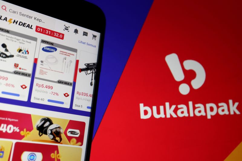 &copy; Reuters. FILE PHOTO: The app of Indonesian e-commerce company Bukalapak is seen on a mobile phone next to its logo displayed in this illustration picture taken July 14, 2021. REUTERS/Florence Lo/Illustration/File Photo