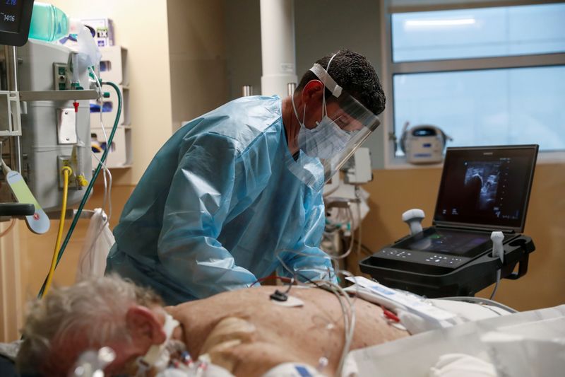 &copy; Reuters. FILE PHOTO: A critical care respiratory therapist works with a coronavirus disease (COVID-19) positive patient in the intensive care unit (ICU) at Sarasota Memorial Hospital in Sarasota, Florida, February 11, 2021. REUTERS/Shannon Stapleton/File Photo