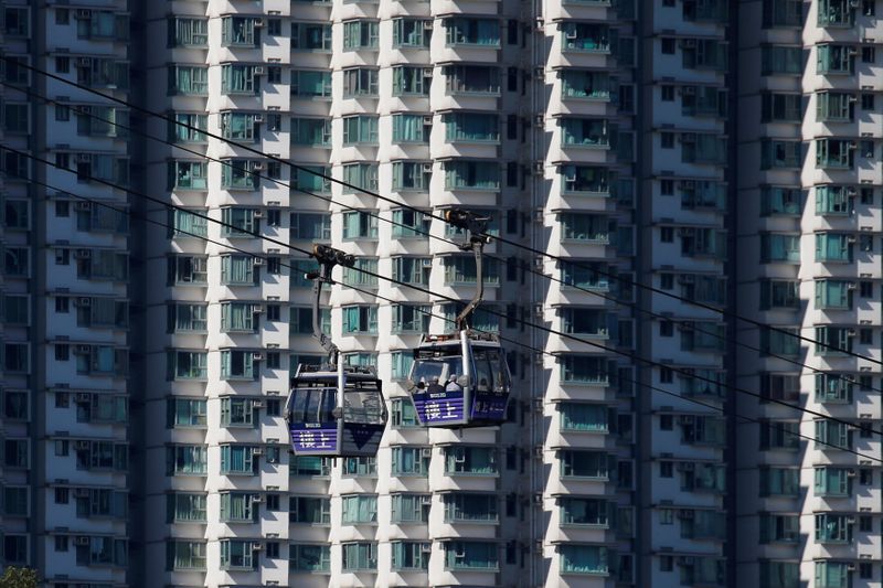 &copy; Reuters. FILE PHOTO: Cable cars move past residential flats at Lantau island in Hong Kong, China May 30, 2018. Picture taken May 30, 2018.     REUTERS/Bobby Yip