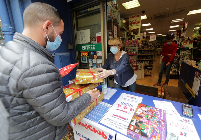 &copy; Reuters. FILE PHOTO: A man picks up his order for Christmas at the 'click and collect' service of the toy shop JoueClub Contesso in Nice as all non-essential stores are closed in France to combat a resurgence of the coronavirus disease (COVID-19) outbreak, France,