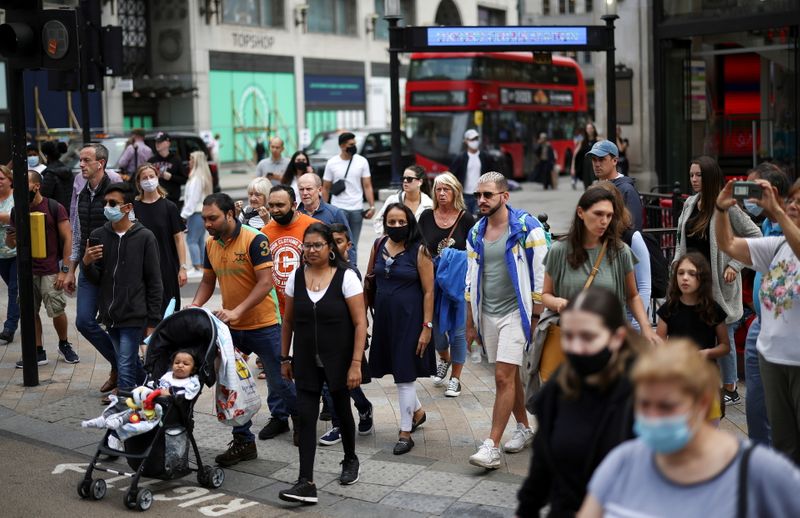 &copy; Reuters. FILE PHOTO: People walk through Oxford Circus, amid the coronavirus disease (COVID-19) outbreak, in London, Britain, July 26, 2021. REUTERS/Henry Nicholls/File Photo