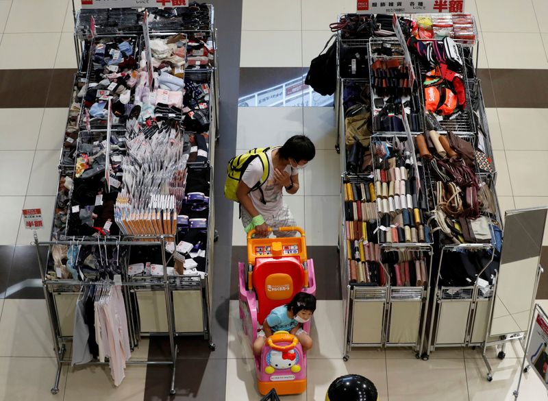 &copy; Reuters. FILE PHOTO: A shopper looks at goods at Japan's supermarket group Aeon's shopping mall as the mall reopens amid the coronavirus disease (COVID-19) outbreak in Chiba, Japan May 28, 2020. REUTERS/Kim Kyung-Hoon/File Photo  