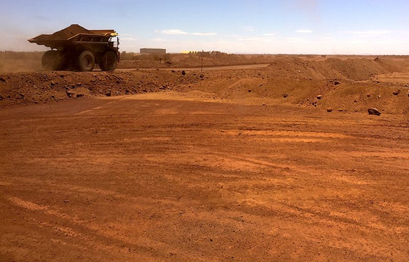 &copy; Reuters. FILE PHOTO: An autonomous vehicle drives along a road as it collects iron ore at Australia's Fortescue Metals Group mine in the Pilbara region, located south-east of the coastal town of Port Hedland in Western Australia, November 29, 2018.  REUTERS/Melani