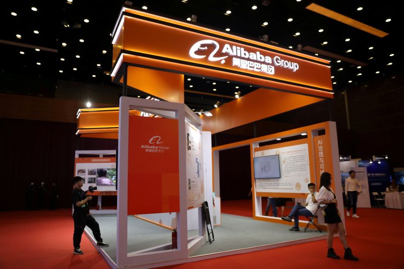 &copy; Reuters. FILE PHOTO: People are seen at a booth of Alibaba Group at an exhibition during China Internet Conference, in Beijing, China, July 13, 2021. REUTERS/Tingshu Wang/File Photo