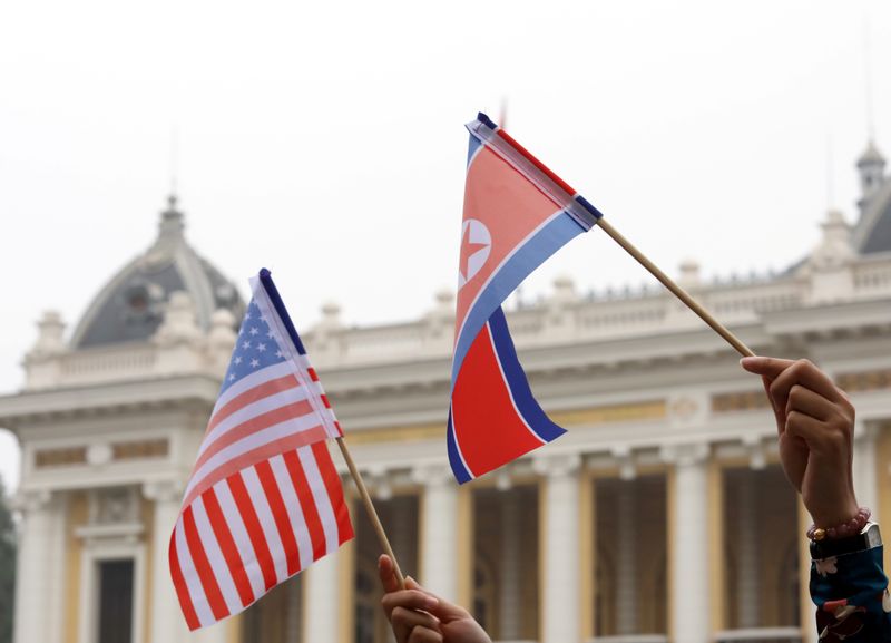 &copy; Reuters. FILE PHOTO: Residents hold US and North Korean flags while they wait for motorcade of North Korea's leader Kim Jong Un en route to the Metropole Hotel for the second US- North Korea summit in Hanoi, Vietnam February 28, 2019. REUTERS/Kham