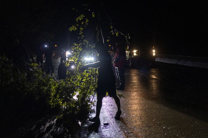 &copy; Reuters. Cajun Navy disaster response team members clear a fallen tree along Highway 90 in the aftermath of Hurricane Ida in Donner, Louisiana, U.S., August 30, 2021.  REUTERS/Adrees Latif