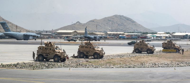 &copy; Reuters. FILE PHOTO: U.S. Army soldiers assigned to the 82nd Airborne Division patrol Hamid Karzai International Airport in Kabul, Afghanistan August 17, 2021. Picture taken August 17, 2021.  U.S. Air Force/Senior Airman Taylor Crul/Handout via REUTERS