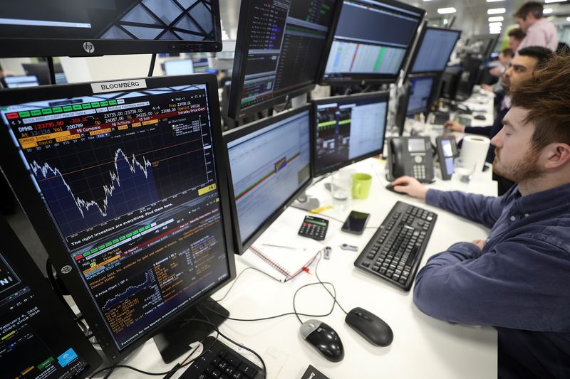&copy; Reuters. FILE PHOTO: Traders looks at financial information on computer screens on the IG Index trading floor in London, Britain February 6, 2018. REUTERS/Simon Dawson