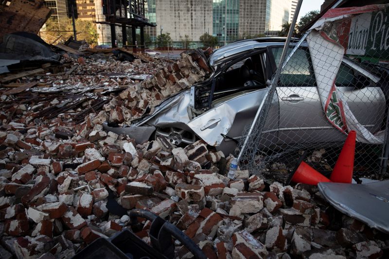 © Reuters. A destroyed car is seen under the debris of a building after Hurricane Ida made landfall in Louisiana, U.S., August 31, 2021. REUTERS/Marco Bello