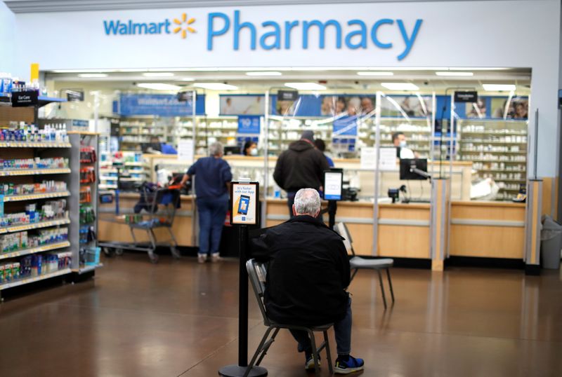 &copy; Reuters. A person waits at a Walmart Pharmacy where the Moderna coronavirus disease (COVID-19) vaccine is available as Walmart and other major U.S. pharmacies take part in the Federal Retail Pharmacy Program, to increase vaccinations in the U.S. in West Haven, Con