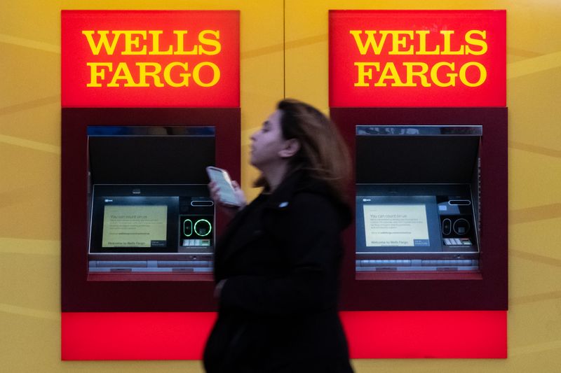 &copy; Reuters. A woman walks past Wells Fargo bank in New York City, U.S., March 17, 2020. REUTERS/Jeenah Moon