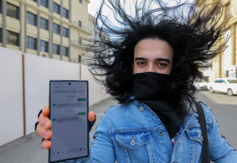 &copy; Reuters. A man shows his mobile phone with permission to leave home, received in a text message, after the authorities imposed restrictions on movement to prevent the spread of the coronavirus disease (COVID-19) in Baku, Azerbaijan April 6, 2020. According to the 