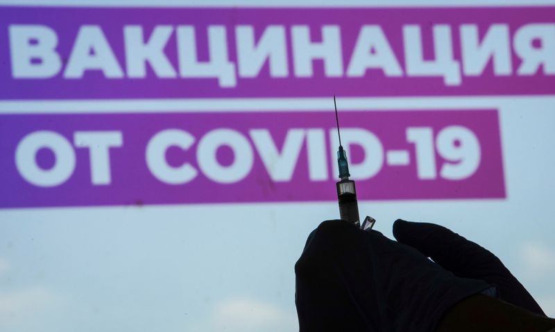 &copy; Reuters. FILE PHOTO: A healthcare worker prepares a one-dose Sputnik Light vaccine against the coronavirus disease (COVID-19) at a vaccination centre in Luzhniki Stadium in Moscow, Russia July 8, 2021. A sign reads Vaccination against COVID-19.  REUTERS/Tatyana Ma