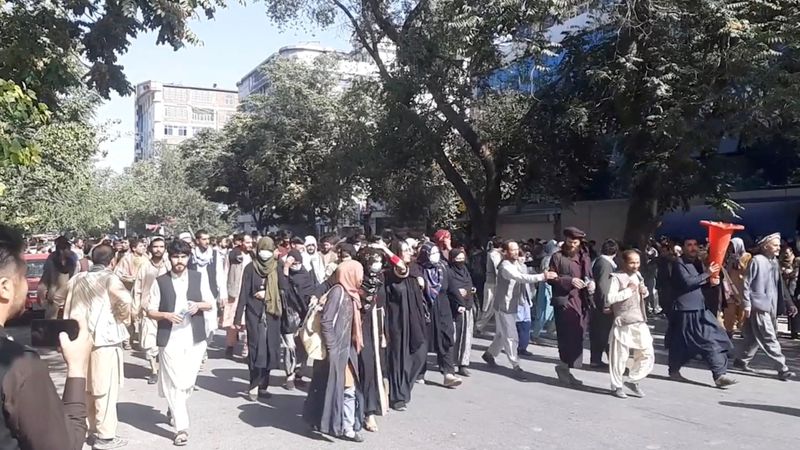 &copy; Reuters. FILE PHOTO: People march in protest near the Central Kabul Bank, in Kabul, Afghanistan, August 28, 2021, in this still image obtained by Reuters from a social media video.