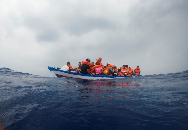 &copy; Reuters. مهاجرون في قارب خشبي ينتظرون الحرس الإيطالي بالقرب من جزيرة لامبيدوزا في البحر المتوسط يوم الأربعاء. تصوير: خوان مدينا  - رويترز.