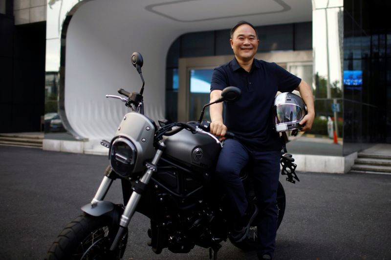 &copy; Reuters. FILE PHOTO: Zhejiang Geely Holding Group's Chairman Li Shufu poses for pictures with a Benelli Leoncino 800 motorcycle at Geely headquarters in Hangzhou, Zhejiang province, China July 20, 2021. REUTERS/Aly Song    