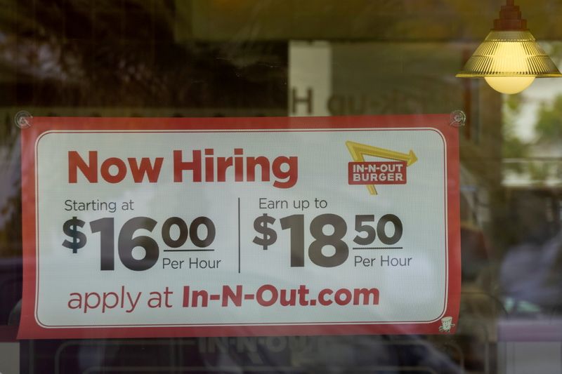 &copy; Reuters. FILE PHOTO: An In-N-Out Burger advertises for workers at their restaurants location in Encinitas, California, U.S., May 10, 2021. REUTERS/Mike Blake/File Photo/File Photo