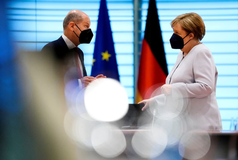 &copy; Reuters. FILE PHOTO: German Chancellor Angela Merkel speaks with Finance Minister Olaf Scholz at the weekly cabinet meeting in Berlin, Germany June 9, 2021. Markus Schreiber/Pool via REUTERS/File Photo