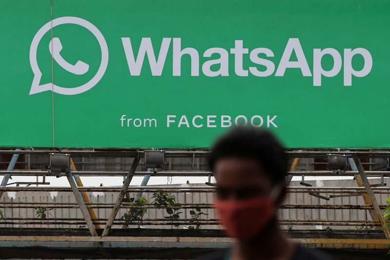 &copy; Reuters. A man walks past a hoarding of the WhatsApp application installed at a skywalk in Mumbai, India, August 26, 2021. REUTERS/Francis Mascarenhas